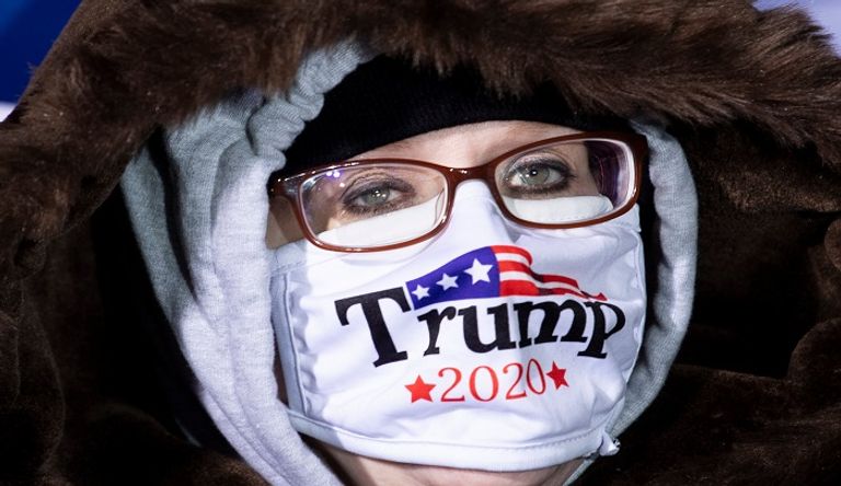 إحدى أنصار الرئيس الأمريكي دونالد ترامب ترتدي كمامة مدون عليها اسمه، في آخر تجمع من حملته الانتخابية، في جراند رابيدز بولاية ميشيجن. الرئيس الأمريكي دونالد ترامب في آخر تجمع انتخابي له- الفرنسية