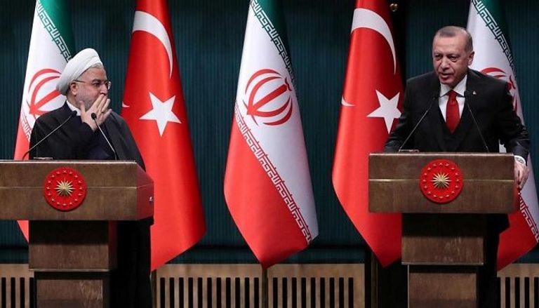 الرئيس التركي رجب طيب أردوغان ونظيره الإيراني حسن روحاني (رويترز)