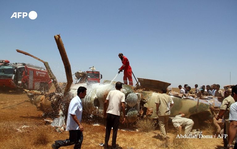 مسعفون يتفحّصون حطام المروحيّة في محيط بنغازي في الرابع من تموز/يوليو 2013 الصورة الخاطئة المتداولة للطائرة