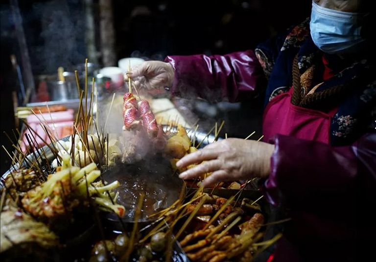 شابة صينية بووهان تعدل من مكياجها في المطعم بمناسبة عيد ميلادها - رويترز