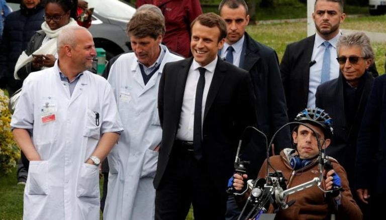 الرئيس الفرنسي إيمانويل ماكرون بجانب أصحاب الهمم والفريق الطبي
