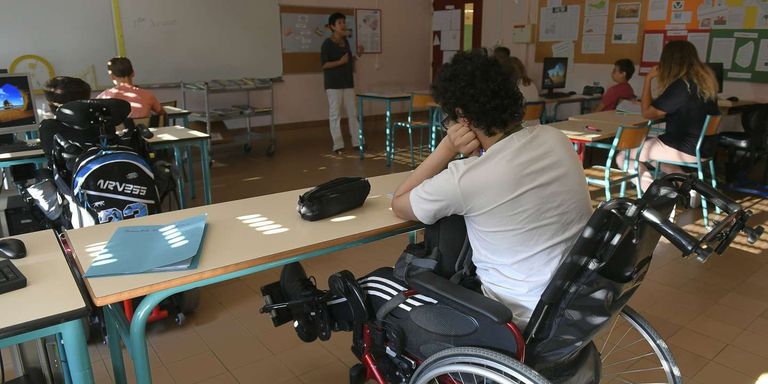 الرئيس الفرنسي إيمانويل ماكرون بجانب أصحاب الهمم والفريق الطبي