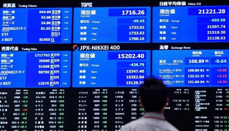 مستثمر يراقب مؤشرات بورصة طوكيو على شاشة التداول