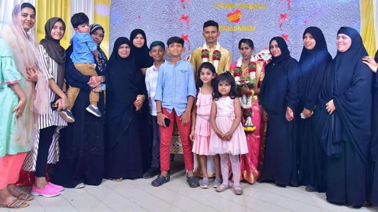 الزوجان يلتقطان صورة زفاف مع الأسرة