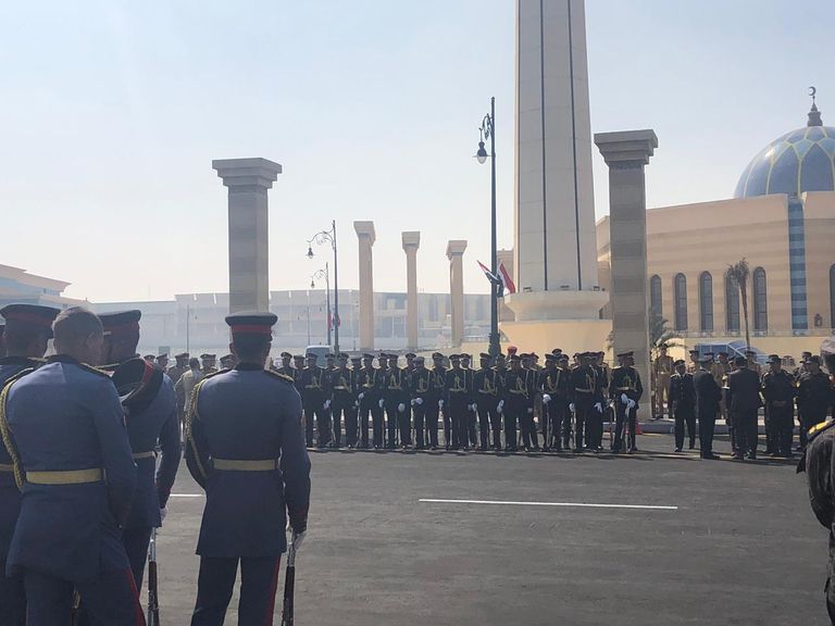 مصري يحمل صورة مبارك أمام المسجد الذي ستقام به صلاة الجنازة