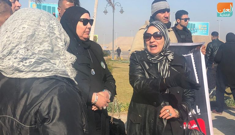 مصري يحمل صورة مبارك أمام المسجد الذي ستقام به صلاة الجنازة