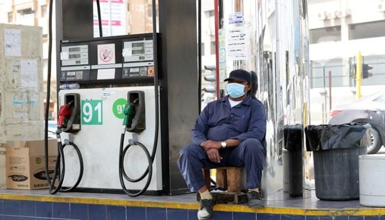 عامل يرتدي قناعا واقيا في محطة بنزين بالسعودية