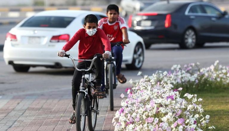 صبيان سعوديان يقودان دراجتيهما في مدينة القطيف