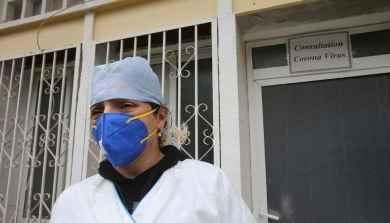 طبيبة أمام مركز لفحص فيروس كورونا في مستشفى بالجزائر