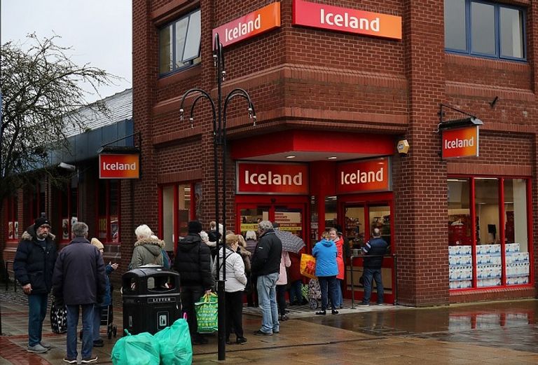 مواطنون يصطفون خارج المتجر لتخزين حاجياتهم  أشخاص يصطفون خارج أحد المتاجر لشراء المستلزمات بعد تفشي كورونا