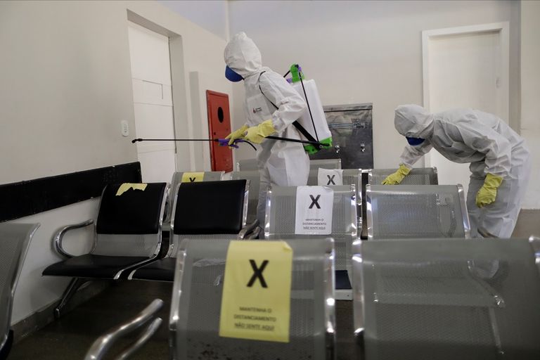 عامل يرتدي بدلة واقية ويرش مطهرات كإجراء احترازي لمنع تفشي كورونا