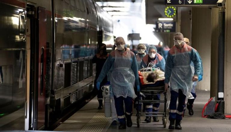 رجال الإسعاف ينقلون مريضا من إحدى محطات القطارات في باريس