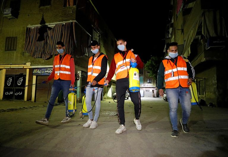 تعقيم شوارع مصر للوقاية من فيروس كورونا فتاة مصرية ترتدي كمامة طبية للوقاية من كورونا