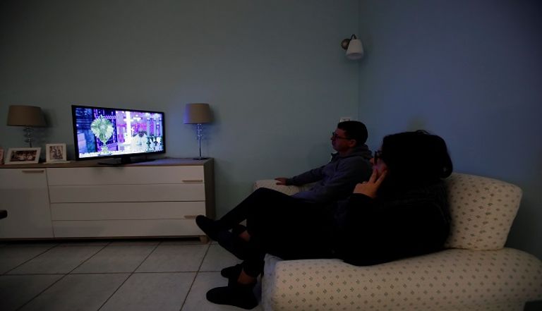 أسرة تشاهد التلفزيون خلال فترة العزل المنزلي نصائح للحفاظ على نظرك خلال العزل المنزلي
