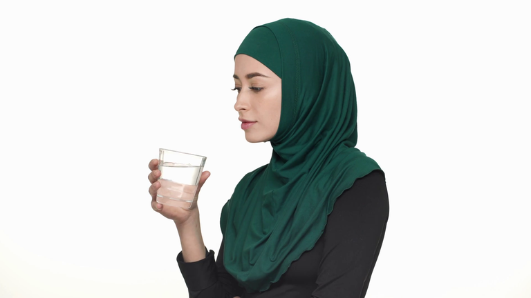 امرأة تتناول كوب ماء كيفية التخلص من العطش في رمضان