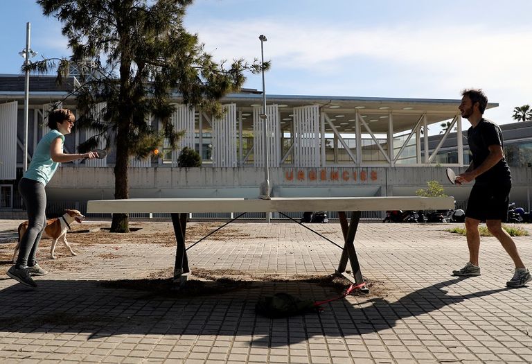 زوجان يلعبان تنس الطاولة أمام غرفة الطوارئ في أحد المستشفيات خلال الساعات التي يُسمح فيها بممارسة التمارين الرياضية في الهواء الطلق، لأول مرة منذ الإعلان عن الإغلاق السماح للإسبان بالتريض لأول مرة منذ 7 أسابيع مع تخفيف إجراءات العزل