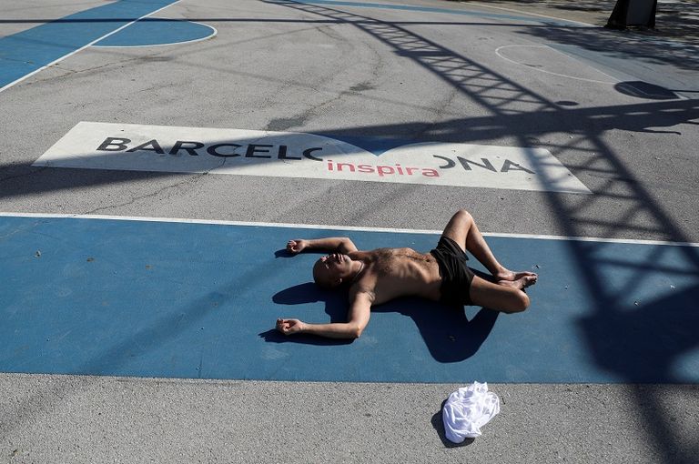 رجل يحصل على حمام شمس خلال الساعات التي يُسمح فيها بممارسة الرياضة في الهواء الطلق السماح للإسبان بالتريض لأول مرة منذ 7 أسابيع مع تخفيف إجراءات العزل