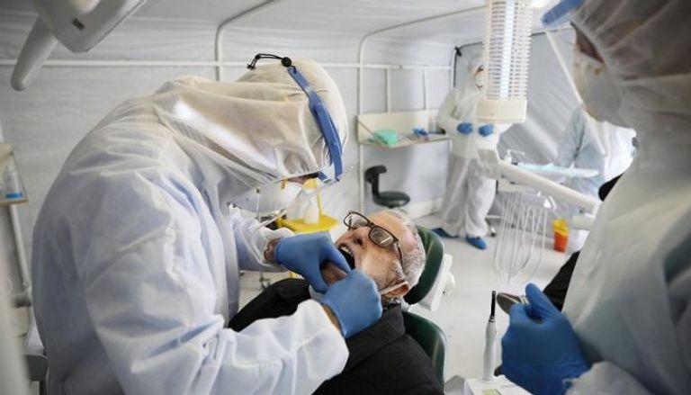 طبيب أردني يفحص أحد المشتبه إصابتهم بفيروس كورونا