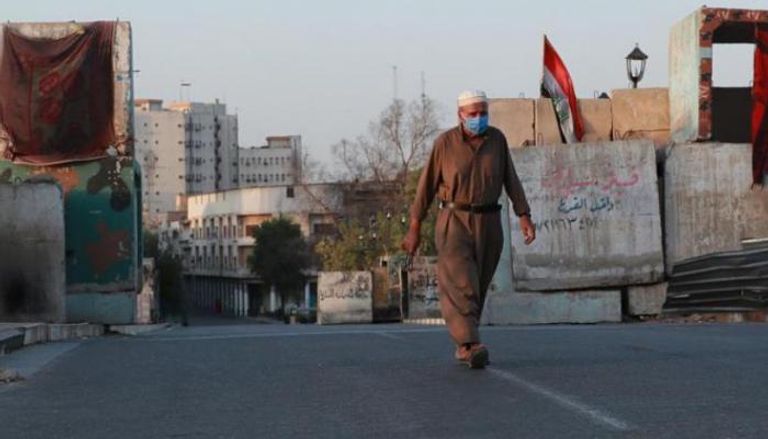 عراقي يسير في أحد شوارع بغداد