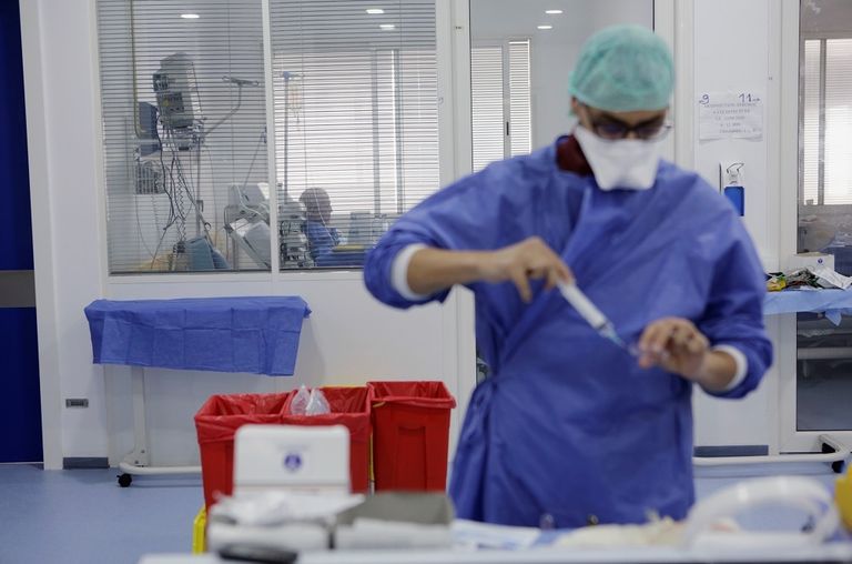 عاملون صحيون ينقلون جثمان امرأة توفيت بفيروس كورونا في الهند