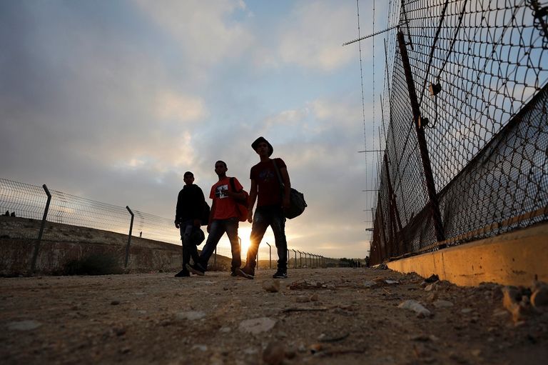 فلسطيني يقف أمام أحد المعابر الإسرائيلية