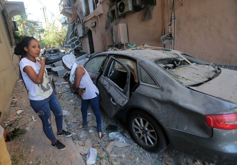 شباب وعناصر أمن يحملون إحدى ضحايا الانفجار