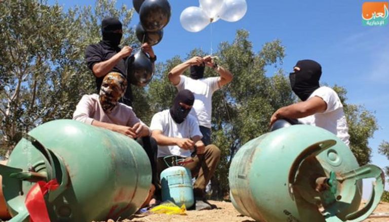 عناصر من حركة حماس تعد بالونات حارقة 