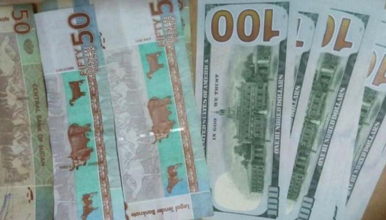 عملات ورقية من الدولار والجنيه السوداني - أرشيف
