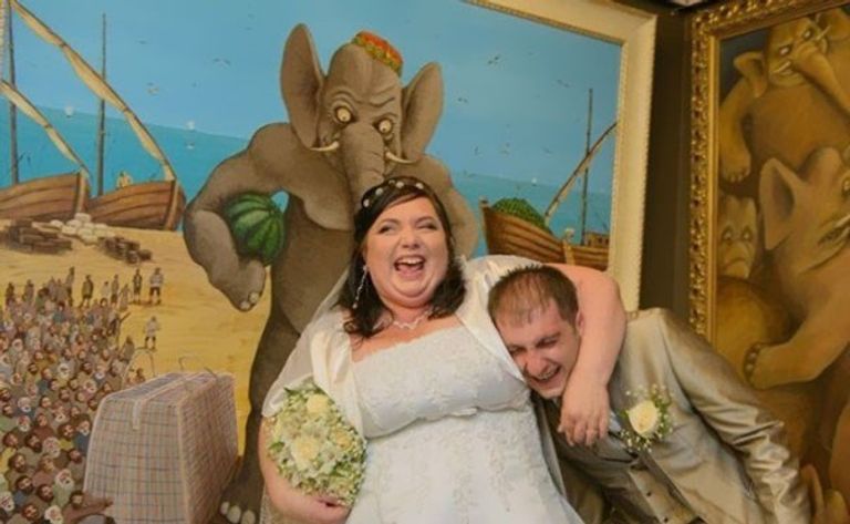 صورة زفاف في روسيا حيث تمسك العروس برأس العريس تحت ذراعه واحدة من صور الزفاف الروسية الغريبة