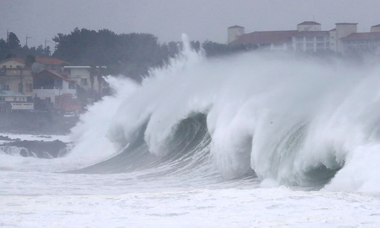 مارة يحتمون بالمظلات من الأمطار الغزيرة في اليابان