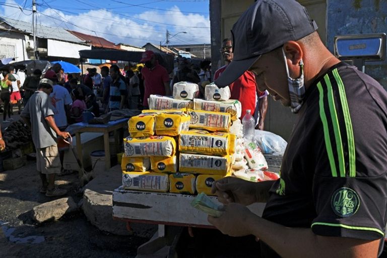 تاجر فنزويلي يبيع الدجاج في سوق بمدينة جويريا شمال فنزويلا – أ ف ب
