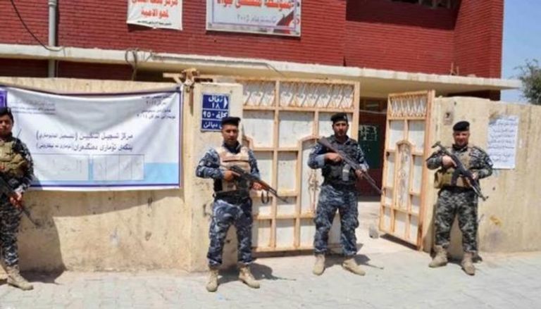 عناصر أمن أمام مركز اقتراع في انتخابات عراقية سابقة