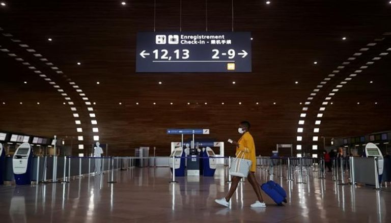 مسافرة داخل مطار شارل ديجول في فرنسا - رويترز