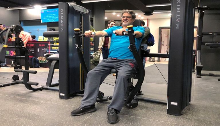 شخص يرتدي كمامة أثناء تواجده في صالة رياضية