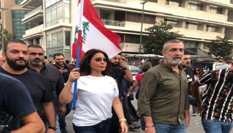 إليسا تحمل علم لبنان في إحدى المظاهرات