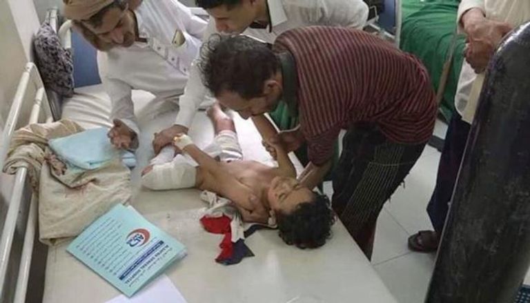 أطباء يحاولون انقاذ طفل مصاب بقذائف الحوثي بتعز