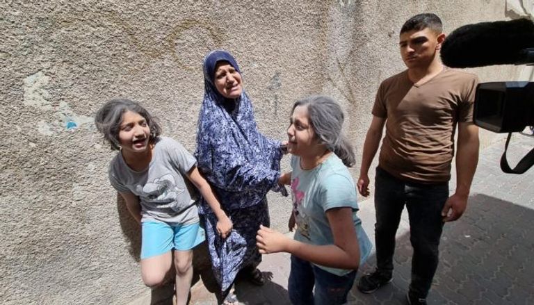 بكاء سيدة وابنتيها بعد القصف الإسرائيلي 
