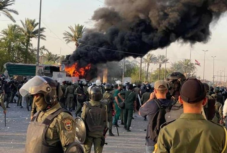 متظاهرون يضرمون النار بكرافانات تابعة لقوات أمنية ببغداد