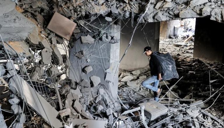 فلسطيني وسط ركام إحدى المباني المتضررة من القصف الإسرائيلي- أ.ف.ب