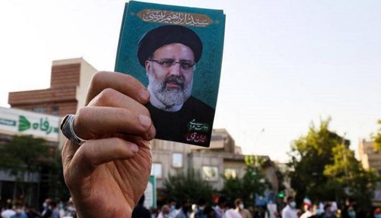 صورة الرئيس الإيراني المنتخب يرفعها أحد أنصاره -أ.ف.ب