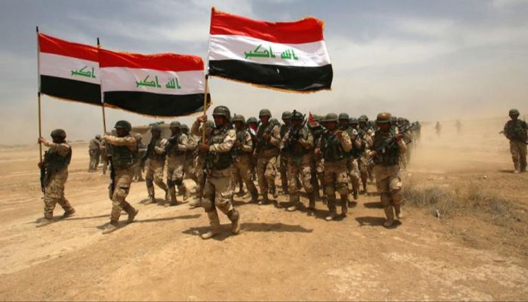 عناصر من القوات العراقية عقب تحرير إحدى المدن من سيطرة داعش