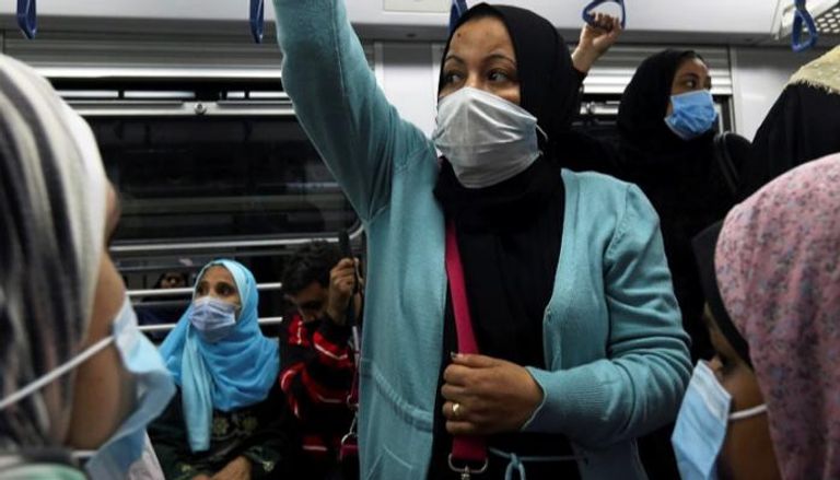 امرأة ترتدي كمامة للوقاية من فيروس كورونا في مترو القاهرة