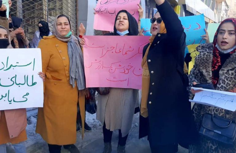 عنصر من طالبان يطالب امرأة بلبس البرقع