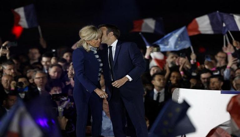 الرئيس الفرنسي إيمانويل ماكرون يقبل زوجته