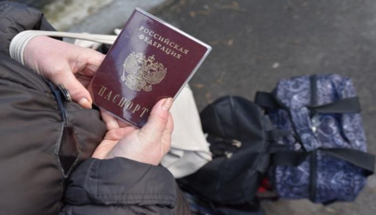 امرأة تحمل جواز سفر روسي