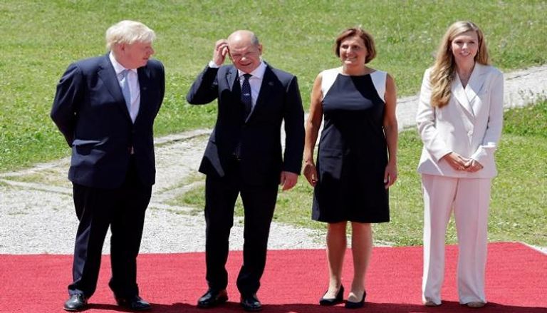 المستشار الألماني وزوجته رفقة رئيس وزراء بريطانيا وقرينته - رويترز