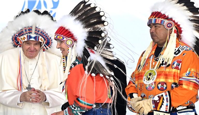 البابا فرنسيس مرتديا غطاء للرأس من الريش - الفرنسية