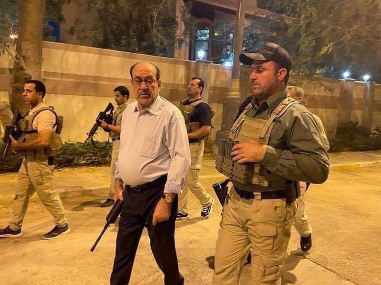 المالكي مسلحاً برفقة حماية شخصية عند المنطقة الخضراء