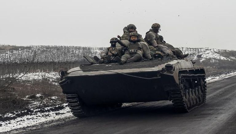 جنود أوكرانيون يركبون فوق مركبة قتال في منطقة دونيتسك - رويترز