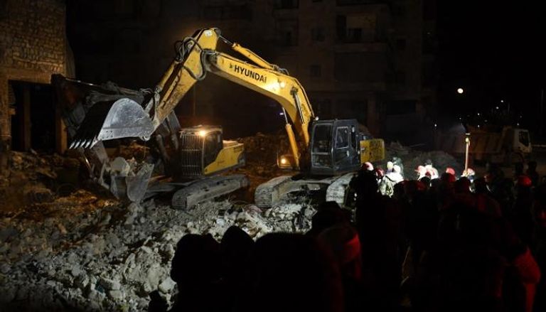 رجال الإنقاذ يبحثون بين أنقاض مبنى منهار في مدينة حلب